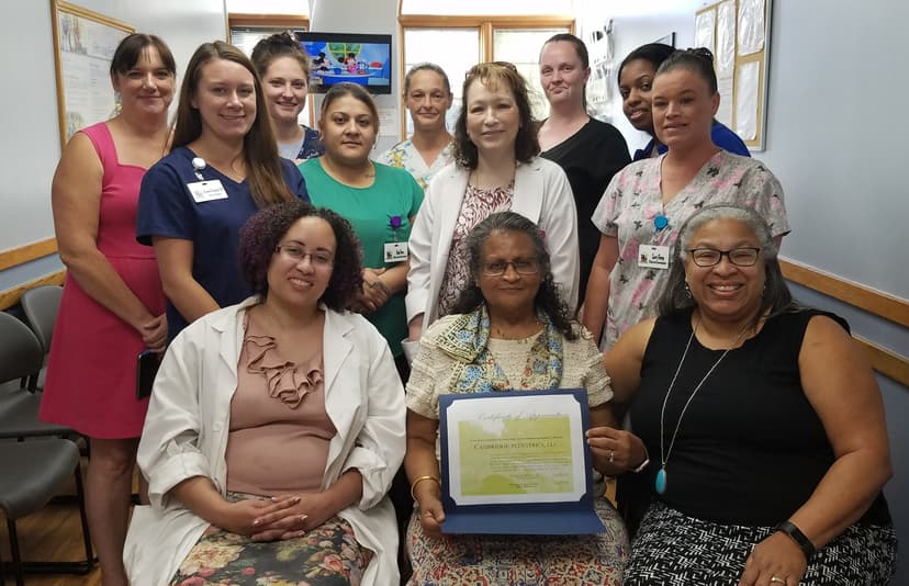 Certificate of Appreciation presentation to Cambridge Pediatrics, LLC - Group photo of Amy Davis presenting the certificate